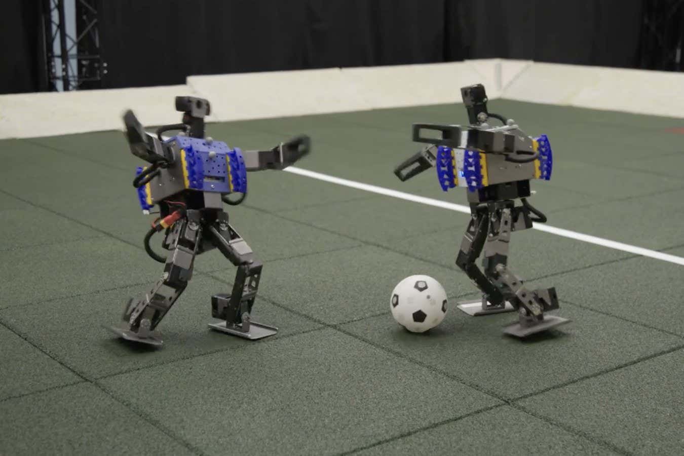 Watch mini humanoid robots showing off their football skills