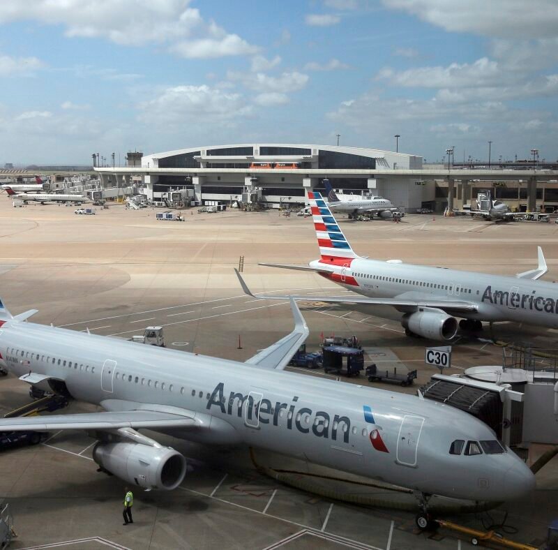 American Airlines faces a discrimination suit after removing 8 Black men from flight : NPR
