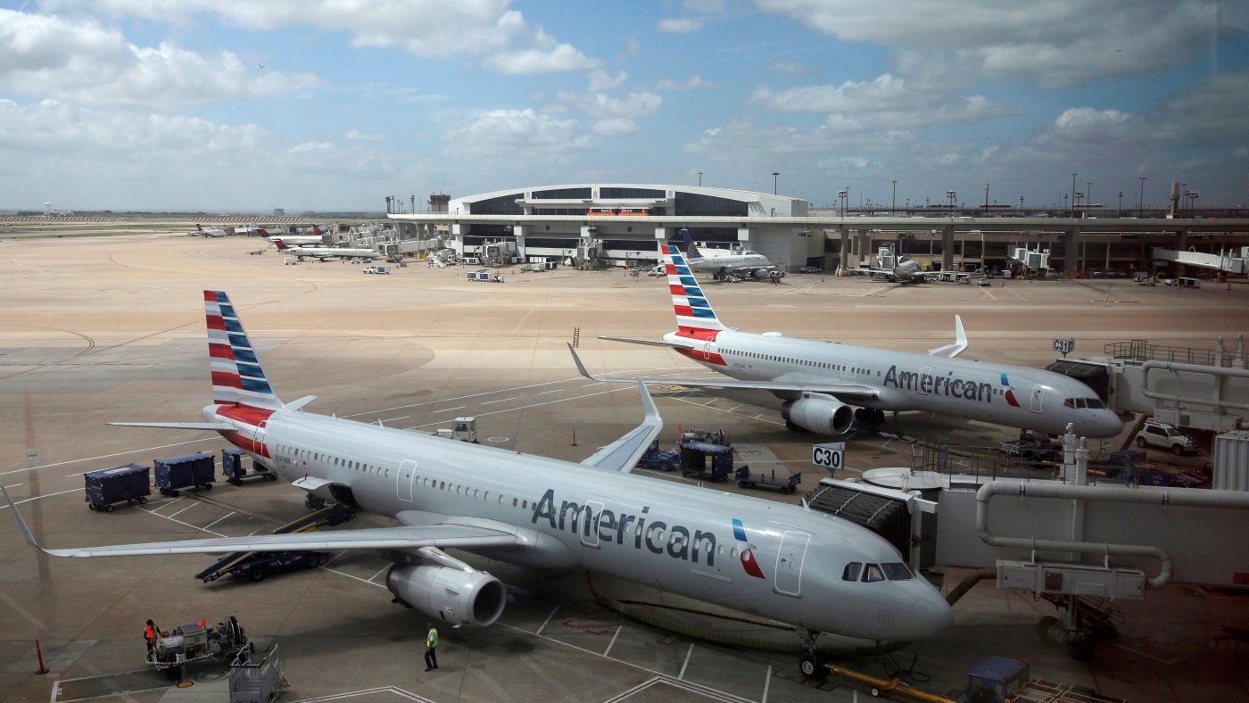 American Airlines faces a discrimination suit after removing 8 Black men from flight : NPR