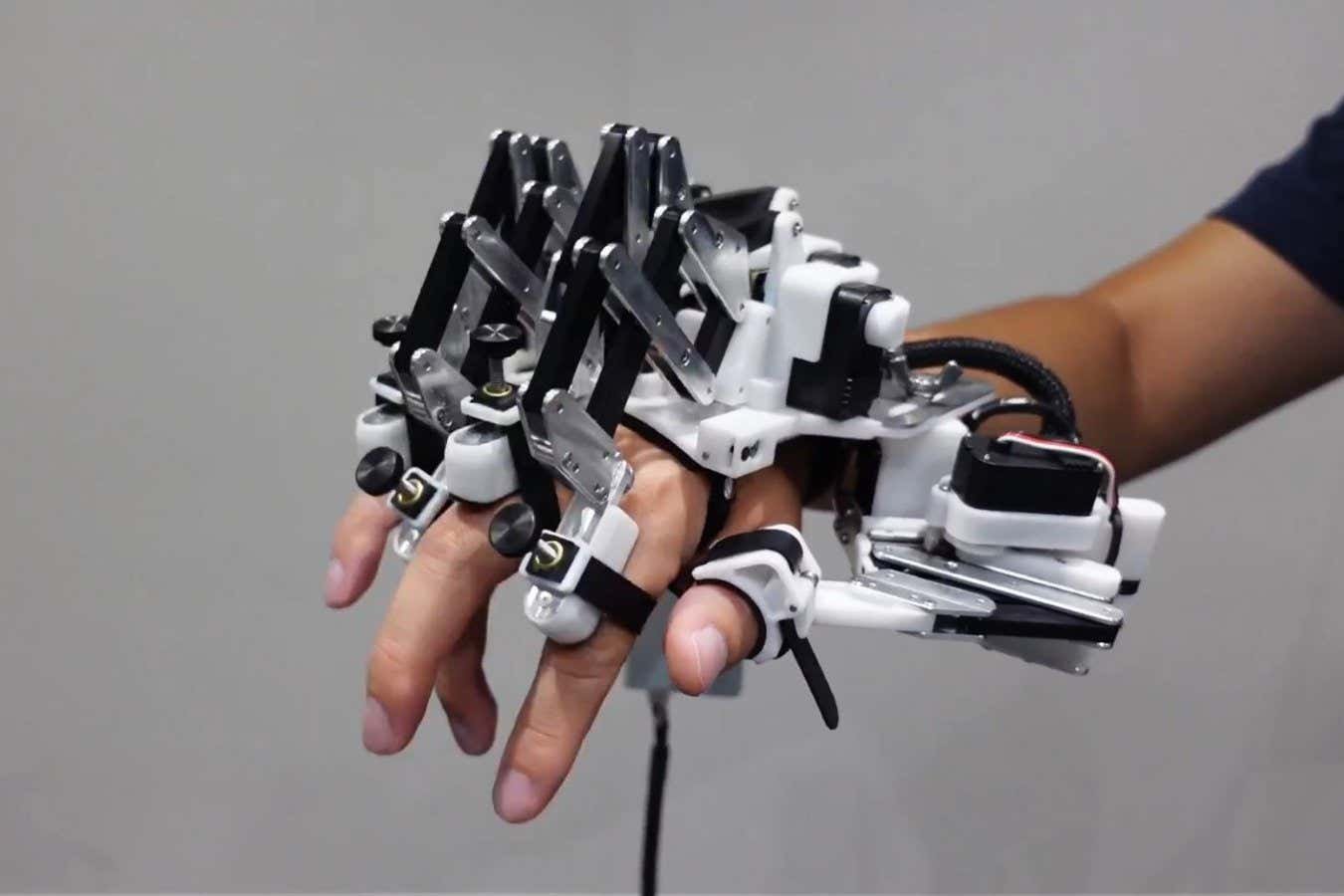 Robotic exoskeleton can train expert pianists to play faster